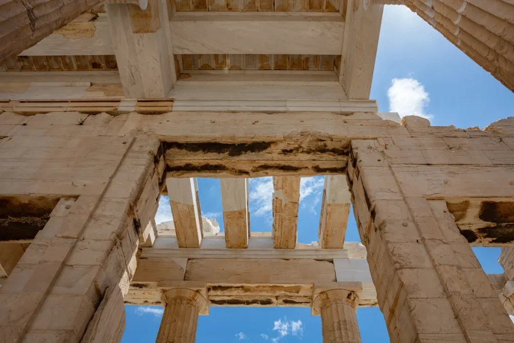 Upward view of the marble columns of the Propylaea gateway at the Acropolis of Athens