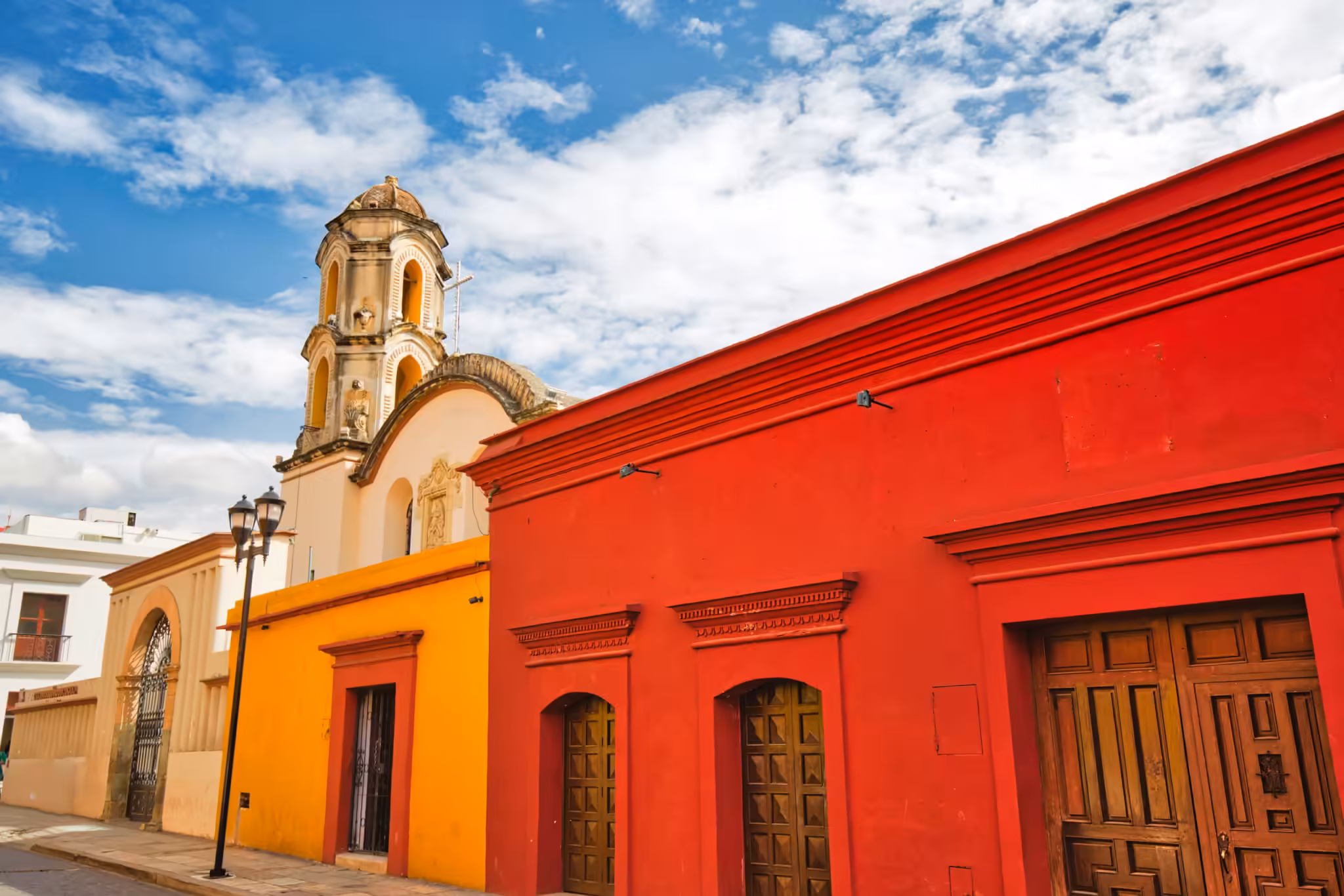 Oaxaca, Mexico: a red colonial street and church facade in the historic centre