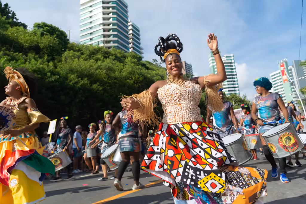 Salvador, Bahia: a dancer in traditional dress leading a pre-Carnival parade